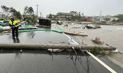 Police check an area destroyed by the wind from Typhoon Kong-rey in Hualien County, eastern Taiwan (AP)
