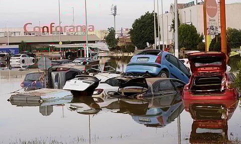 Cars are seen half submerged after floods in Valencia, Spain (AP)