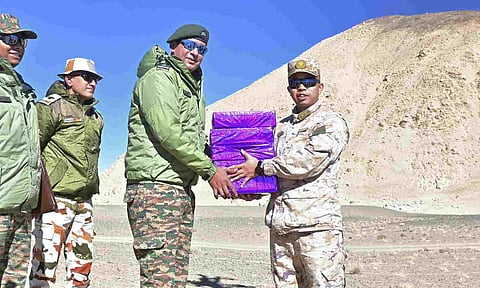 Indian and Chinese Army personnel exchange sweets on the Diwali festival, at a border point along LAC (PTI)&nbsp;