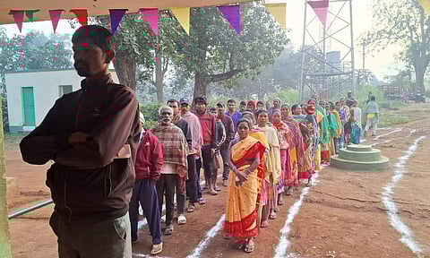 Voters wait in queues at a polling station to cast votes during the 1st phase of Jharkhand Assembly elections, in West Singhbhum district of Jharkhand (PTI)
