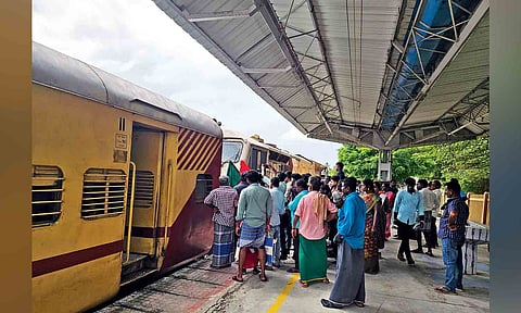 Passengers gathered near snag-hit train at Peravurani railway station on Friday