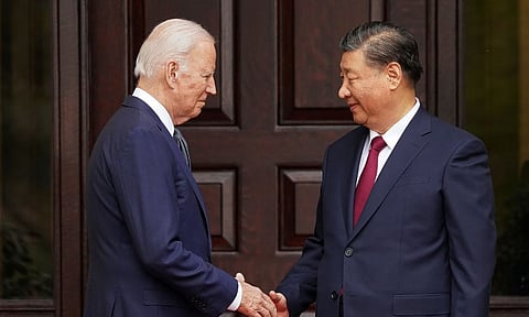 Joe Biden shaking hands with Xi Jinping (AP)