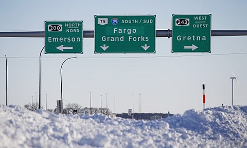 Road signage is posted just outside of Emerson, Manitoba (AP)