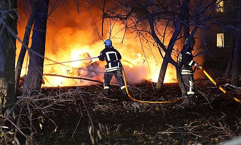 Firefighters extinguish the fire following a Russian rocket attack that hit a multi-storey apartment building in Sumy