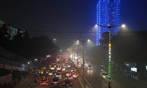 Vehicles move on a road amid fog, at ITO, in New Delhi (PTI)&nbsp;