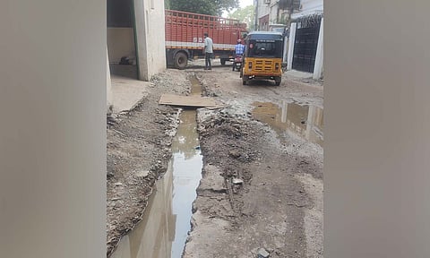 The pit dug up for the stormwater drain maintenance filled with rainwater on Pillaiyar Koil Street