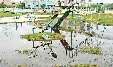 Play equipment amid stagnant water in the park&nbsp;