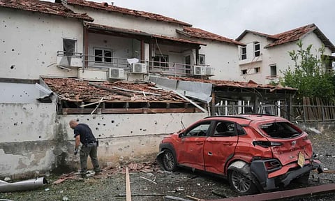 Israeli police bomb squad inspect the site after a missile fired from Lebanon (AP)