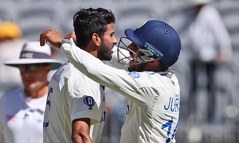 India's Washington Sundar, left, and teammate Dhruv Jurel celebrate the wicket of Australia's Mitchell Starc on the fourth day of the first cricket test between Australia and India (PTI)