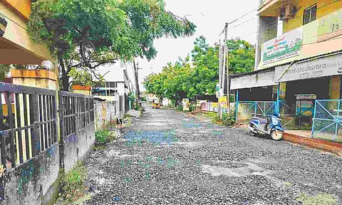 The road in Noombal has an uneven surface and is filled with potholes
