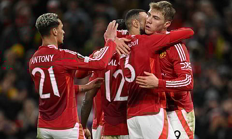Manchester United players celebrate scoring the second goal