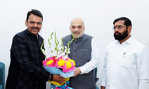 Union Minister and senior BJP leader Amit Shah, Maharashtra BJP leader Devendra Fadnavis, Shiv Sena leader Eknath Shinde exchange greetings during a meeting (PTI)