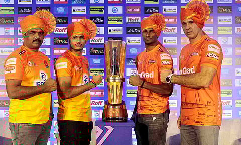 Players of Puneri Paltan and U Mumba pose with the trophy
