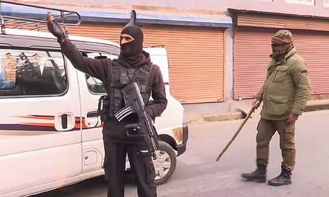 Security personnel stand guard on a road amid a joint operation by Indian Army &amp; J&amp;K Police, in Srinagar