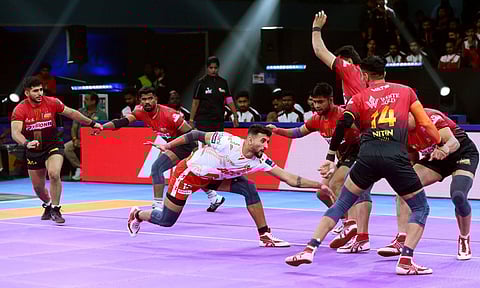 Gujarat's Guman Singh goes for a raid against Bengaluru Bulls