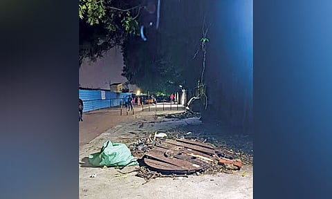 Wood waste lying haphazardly on the pedestrian pathway along the railway station