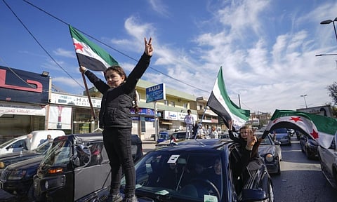 Syrians celebrate the fall of Bashar Assad's government (AP)