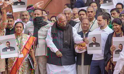 Mallikarjun Kharge with Rahul Gandhi and other opposition MPs stages a protest over the Adani issue and Manipur unrest during the Winter session of Parliament, in New Delhi (PTI)&nbsp;
