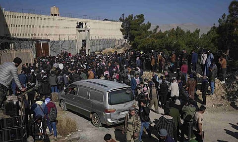 People stand outside the infamous Saydnaya military prison, just north of Damascus, Syria (AP)