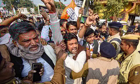 Police personnel try to stop Congress workers and supporters during their protest march to Raj Bhavan in Patna on Wednesday (PTI)