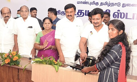 Deputy Chief Minister Udhayanidhi Stalin giving away welfare aid to a beneficiary in Tirupur on Thursday