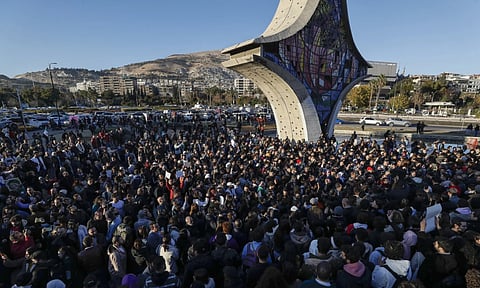 Syrian activists gather at the Umayyad square during a protest to demand a secular state, in Damascus, Syria (AP Photo)