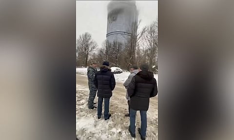 Local officials look at a damage site at the residential complex called "Lazurnye Nebesa," or Azure Skies, in Kazan (AP)