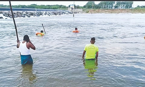 Police and rescue personnel searching for the trio’s bodies