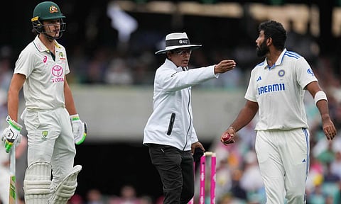 Umpire Sharfuddoula Saikat, centre, gestures to India's Jasprit Bumrah, right, as he exchanges words with Australia's Sam Konstas,&nbsp;left&nbsp;(AP)