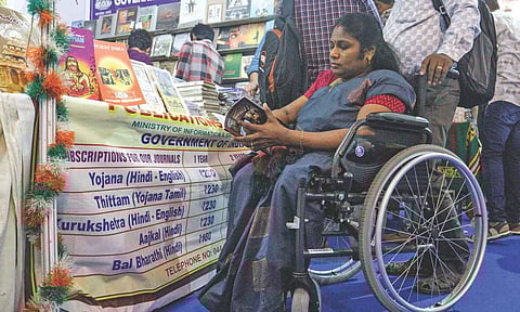 Wheelchair users find it difficult to navigate small stalls and muddy pathways at the Book Fair (Photo: Hemanathan)