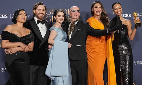Adriana Paz, from left, Edgar Ramirez, Selena Gomez, Jacques Audiard, Karla Sofia Gascon, and Zoe Saldana pose in the press room with the award for best motion picture - musical or comedy for "Emilia Perez" during the 82nd Golden Globes (AP)