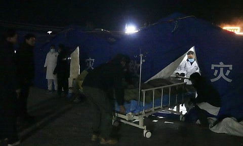 Medical workers treat injured people at the temporary tents set up at the People's Hospital in the aftermath of an earthquake (AP)