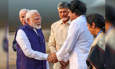 Prime Minister Narendra Modi being received by Andhra Pradesh Deputy Chief Minister Pawan Kalyan upon his arrival, in Visakhapatnam, Andhra Pradesh (PTI)&nbsp;
