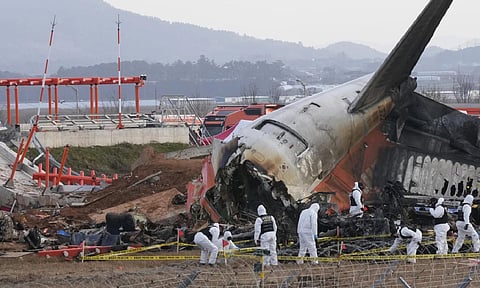 Rescue team members work at the site of a plane crash at Muan International Airport in Muan, South Korea, Tuesday, Dec 31,2024 (AP)&nbsp;