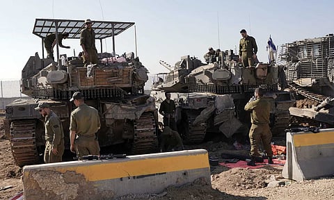Israeli soldiers work in a staging area on the Israel-Gaza border after returning from the Gaza Strip on Jan 18,2025, a day ahead of a ceasefire between Israel and Hamas (AP)&nbsp;