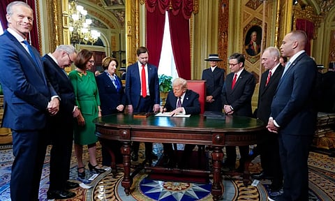 President Donald Trump takes part in a signing ceremony in the President's Room after the 60th Presidential Inauguration (AP)