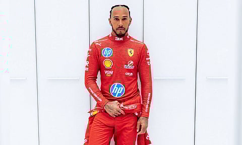Seven-time Formula One World Champion Lewis Hamilton donning the red suit for the first time (X)