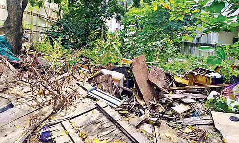 Solid waste and damaged furniture materials dumped on vacant land along Madha Church Road in Mylapore&nbsp;