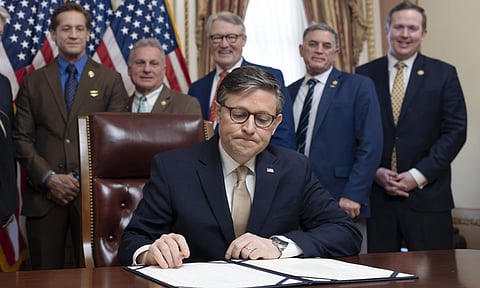 House Speaker Mike Johnson, puts his signature on the Laken Riley Act with members of the Georgia congressional delegation attending, at the Capitol in Washington (AP)