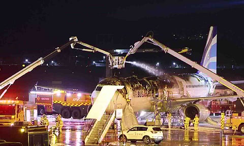 Firefighters work to extinguish a fire on an Air Busan airplane at Gimhae International Airport in Busan, South Korea (AP)