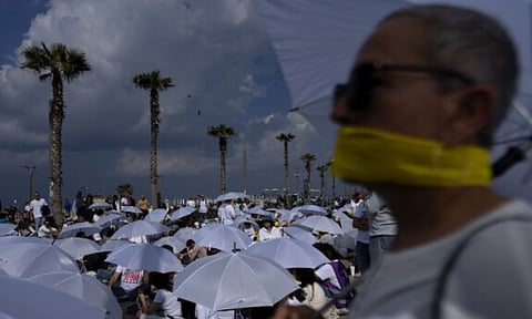 Activist sit on a road during a protest calling for a release of Hamas (AP)