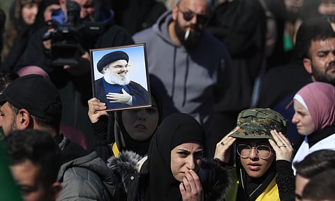 Lebanese citizens gathe to return to their villages, while Israeli soldiers block a road leading to the southern Lebanese village of Kfar Kila, Lebanon (AP)