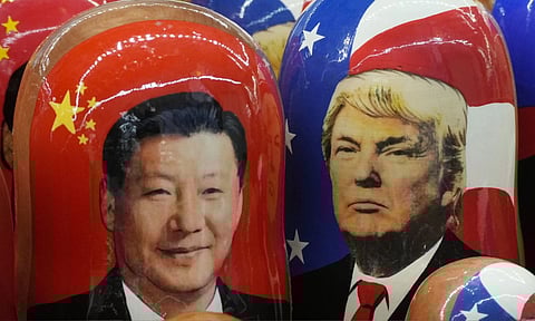Traditional Russian wooden dolls called Matryoshka depicting China's President Xi Jinping, left, and U.S. President Donald Trump are on sale at a souvenir shop in St. Petersburg, Russia (PTI)