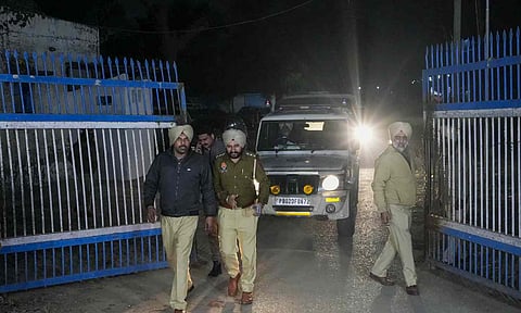 Police personnel take deported immigrants for initial questioning after a US military aircraft carrying them landed at the Shri Guru Ramdas Ji International Airport, in Amritsar (PTI)
