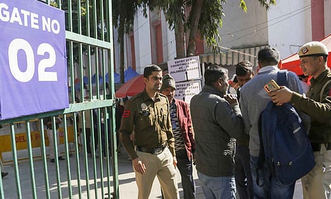 Police personnel conduct security checks at a counting center on the eve of the Delhi Assembly election results (PTI)
