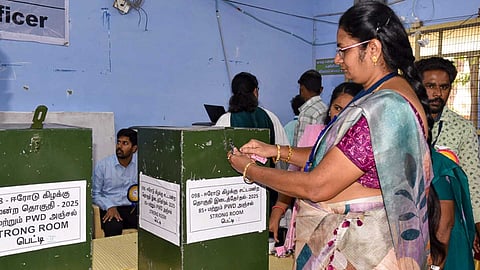 Polling officials check postal votes at a counting center during the counting of votes for the Erode East Assembly by-election (PTI)