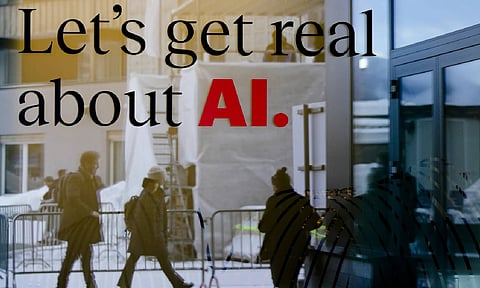 People are reflected in a window of a hotel at the Davos Promenade in Davos, Switzerland (AP)