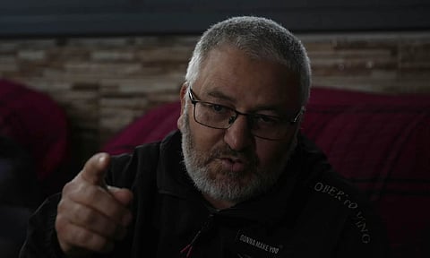 Mohammed Shula speaks at a relative's house, where he and his wife have taken refuge, in the West Bank village of Kafr al-Labad, Monday (AP)