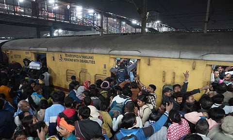 Heavy rush of passengers to catch a train for Mahakumbh, at the New Delhi railway station, Saturday (PTI)