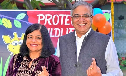 Election Commissioner Gyanesh Kumar shows his inked finger after casting his vote at a polling booth during the Delhi Assembly elections (PTI)